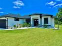 This well-maintained home has a pristine lawn, modern design, and a welcoming front entrance at 22 Medalist Cir, Rotonda West, FL 33947