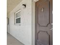 Exterior shot of unit 531 featuring a secure, modern door, bright window, and smooth walkway at 2220 Stickney Point Rd # 531, Sarasota, FL 34231