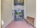 Entrance to The Sunset House condos with new glass doors and updated fixtures at 225 Hourglass Way # 101, Sarasota, FL 34242