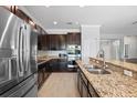 Modern kitchen features stainless steel appliances, granite countertops, and dark wood cabinetry at 2254 50Th Street E Cir, Palmetto, FL 34221