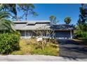 Charming home with a welcoming front yard and a convenient attached two-car garage at 2511 Lords Ln, Sarasota, FL 34231