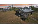 Backyard of home featuring deck and stairs to the grass at 28706 102Nd E Dr, Myakka City, FL 34251