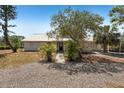 Home with a quaint front porch and mature landscaping at 28706 102Nd E Dr, Myakka City, FL 34251
