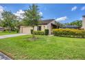 Beautiful home with lush green lawn, lovely landscaping, and an attached garage at 3698 Glen Oaks Manor Dr, Sarasota, FL 34232
