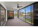 Enclosed lanai with a ceiling fan and views of the surrounding neighborhood at 5122 Marsh Field Rd # 62, Sarasota, FL 34235