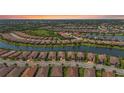 Aerial view of a neighborhood with lake, showcasing the tiled roofs, lush landscaping, and community layout at 5388 Bartolomeo St, Sarasota, FL 34238