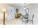 Cozy dining area with tile flooring, decorative lighting, and seating for four, perfect for intimate meals at 5631 Midnight Pass Rd # 1007, Sarasota, FL 34242