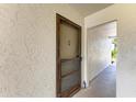 Condo front door with screen and lock, offering privacy and security in a quiet community at 5631 Midnight Pass Rd # 1007, Sarasota, FL 34242