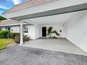 Spacious carport features a well maintained floor and tropical accents at 565 Sutton Place, Longboat Key, FL 34228