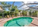 A refreshing swimming pool in a screened enclosure offers the perfect spot to unwind and enjoy the outdoors at 6620 Saint James Xing, University Park, FL 34201