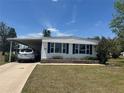 Charming single-story home with a covered parking area and well-maintained landscaping at 6882 Holo Ct, North Port, FL 34287