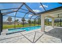 Relaxing screened-in pool and spa with a spacious covered patio area, perfect for entertaining at 7116 Quarry St, Englewood, FL 34224