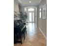 Elegant entryway featuring neutral walls, stylish tile flooring, and a grand piano, creating a welcoming atmosphere at 7360 Talon Bay Dr, North Port, FL 34287