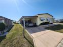 Exterior showcasing the well-maintained lawn, covered parking, and bright exterior of the home at 808 53Rd E Ave # 229, Bradenton, FL 34203