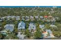 Gorgeous aerial view of waterfront home with private dock and lush landscaping at 5024 Commonwealth Dr, Sarasota, FL 34242