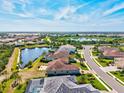 This aerial shot showcases the community's serene lake views and well-maintained streets at 10816 O Meara Way, Englewood, FL 34223