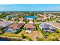 This aerial shot showcases the community's serene lake views and lush landscaping at 10816 O Meara Way, Englewood, FL 34223