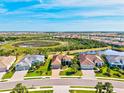 This aerial shot displays the community's serene lake views and lush landscaping at 10816 O Meara Way, Englewood, FL 34223