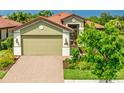 Beautiful home featuring a terra cotta roof, neutral tones, and a well-manicured lawn at 1358 Cielo Ct, North Venice, FL 34275