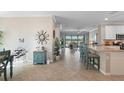 Open floorplan showcasing the kitchen and living area with views of the lanai and lake at 14309 Carolina Sky Pl, Lakewood Ranch, FL 34211