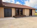 Beautiful front of home with unique architectural details, dark trim, and attractive landscaping at 1438 Vermouth Ln, Punta Gorda, FL 33983