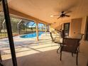 Covered outdoor patio space with ample seating for entertaining with an in-ground pool at 1438 Vermouth Ln, Punta Gorda, FL 33983