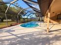 Relaxing private pool with screened-in enclosure and comfortable lounge area at 1438 Vermouth Ln, Punta Gorda, FL 33983