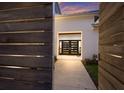 Inviting entryway with a modern door, enhanced by warm lighting and a glimpse of the home's interior at 238 Island Cir, Sarasota, FL 34242