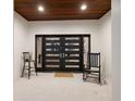 Stylish front door with sleek design, flanked by decorative chairs, offering a welcoming entrance to the home at 238 Island Cir, Sarasota, FL 34242