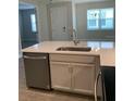 Modern kitchen featuring stainless steel appliances, sink and faucet, cabinets, and quartz countertops at 240 Ibiza Loop, Venice, FL 34292