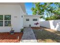 Inviting entrance with a paved walkway, modern exterior lighting, and manicured landscaping at 3090 6Th St, Sarasota, FL 34237