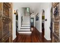 Inviting foyer with hardwood floors, arched doorways, and a staircase leading to the upper level at 344 N Lantana N Ave, Sarasota, FL 34243