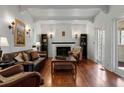 Cozy living room featuring hardwood floors, a fireplace, and ample natural light at 344 N Lantana N Ave, Sarasota, FL 34243