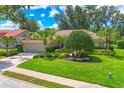 Well-maintained front yard with mature trees and landscaping at 4356 Highland Oaks Cir # 3, Sarasota, FL 34235