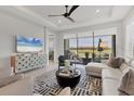 Bright living room featuring a large sliding glass door offering scenic views of the outdoor patio and lake at 4750 Tortona Ct, Bradenton, FL 34211