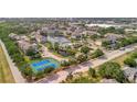 Beautiful aerial view of the community featuring lush landscaping, tennis courts, and a tranquil pond at 4802 51St W St # 107, Bradenton, FL 34210