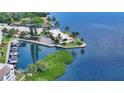 Eye-level view of waterfront house with private docks and lush tropical landscaping overlooking the tranquil bay at 4968 Gulf Of Mexico Dr # Villa 22, Longboat Key, FL 34228