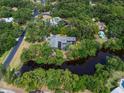 Stunning aerial view of a beautiful home with a pool, surrounded by lush greenery and a tranquil pond at 5282 Box Turtle Cir, Sarasota, FL 34232