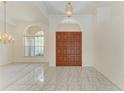 Bright foyer with tile flooring, chandelier, and double door entry at 5533 Ashley Pkwy, Sarasota, FL 34241