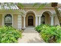 Close up of front entrance with double doors and manicured landscaping at 5533 Ashley Pkwy, Sarasota, FL 34241