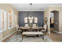 Tastefully designed dining room with modern lighting, elegant decor, and large windows that bring in natural light at 6231 Cypress Bend Ct, University Park, FL 34201