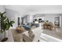 Open-concept living room with contemporary furnishings, natural light, and modern decor at 6384 Grayson St, Englewood, FL 34224
