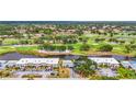 Stunning aerial view of the property showcasing its proximity to a golf course and water features at 7391 W Country Club N Dr, Sarasota, FL 34243
