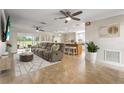 Open-concept living area featuring tile floors, ceiling fans, and seamless access to the kitchen and dining spaces at 7391 W Country Club N Dr, Sarasota, FL 34243