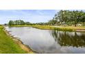 Scenic view of the pond and the golf course creating a tranquil and picturesque backdrop at 7391 W Country Club N Dr, Sarasota, FL 34243