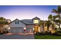 Stunning home with a three-car garage, beautiful landscaping, and a charming front entrance at 801 Seascape Pl, Sarasota, FL 34240