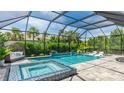Relaxing backyard pool and hot tub featuring lounge chairs and serene landscaping at 801 Seascape Pl, Sarasota, FL 34240