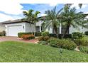 Charming single-story home with lush landscaping and an attached two-car garage at 1034 Buttercup Gln, Bradenton, FL 34212