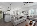 Bright living room with an open-concept design, modern furniture, and natural light at 10464 Ladybug Cv, Parrish, FL 34219