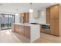 Modern kitchen with sleek cabinets, an island with quartz countertops, and stainless steel appliances at 1052 Concord W Dr, Dunedin, FL 34698